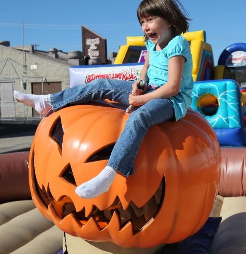 Child riding the pumpkin attraction at Brasee's